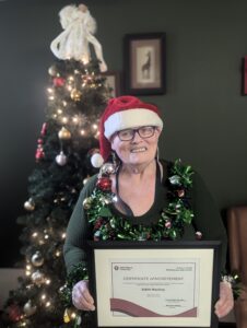 Edith MacKay holding her certificate